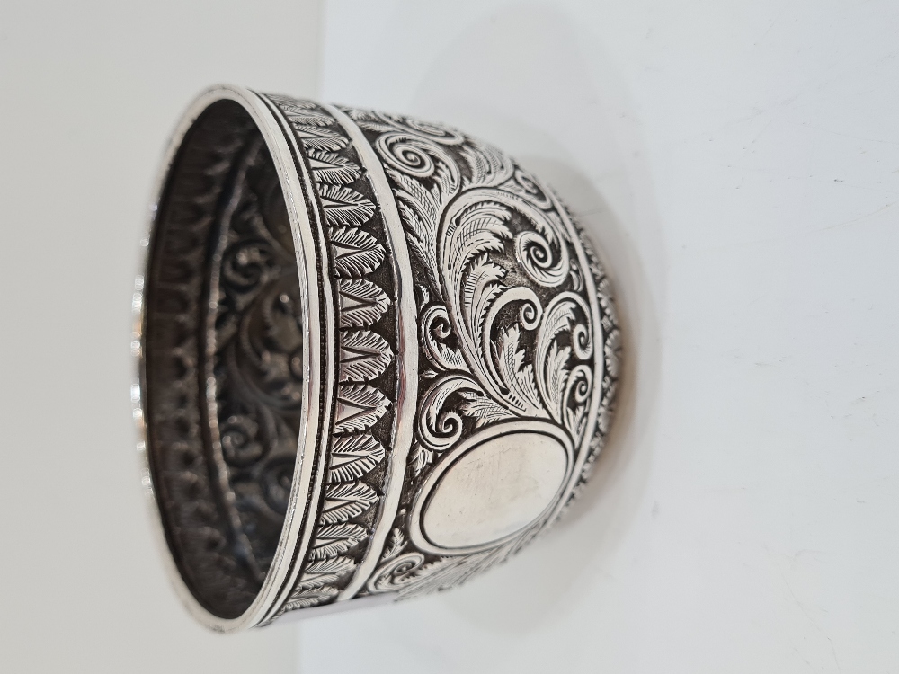 A heavily embossed Victorian Silver bowl having foliage scrolls in relief. The base engraved with or