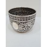 A heavily embossed Victorian Silver bowl having foliage scrolls in relief. The base engraved with or