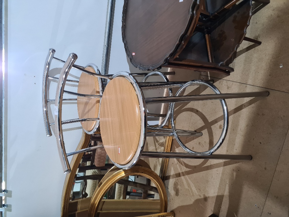 A pair of modern chrome plated bar stools