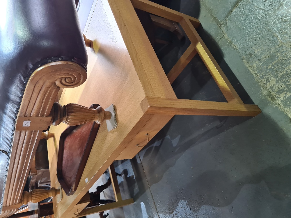 A contemporary oak writing table having 2 drawers, 160cm on square legs