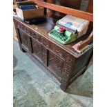 An antique oak coffer having carved panelled front, 128cm