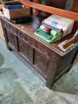 An antique oak coffer having carved panelled front, 128cm