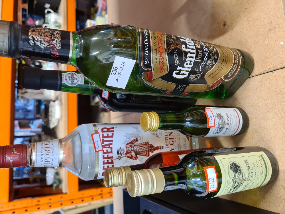 A 1 litre bottle of Glen Fiddich, a bottle of Beafeater Gin and others