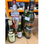 A 1 litre bottle of Glen Fiddich, a bottle of Beafeater Gin and others