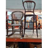 An old stained beech correction chair with cane seat and one other child's rocking chair