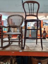 An old stained beech correction chair with cane seat and one other child's rocking chair