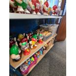 M & M's, a shelf of collectables to include tins, mugs, figures and similar