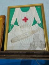 A world War I nurse's apron in glazed frame (glass broken)