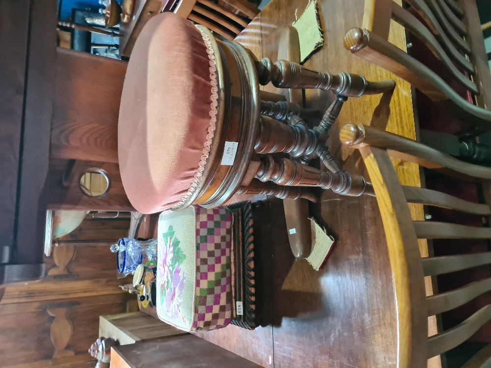 An old Walnut revolving piano stool and a footstool having tapestry cover