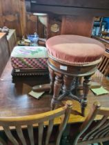 An old Walnut revolving piano stool and a footstool having tapestry cover