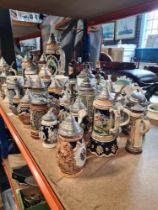 A large selection of German steins, majority with pewter lids