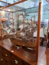 A wooden model of HMS Victory, under glazed top with mirror back (no base)