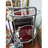 A vintage chrome two tier tea trolley of oval form