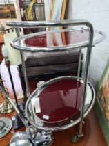 A vintage chrome two tier tea trolley of oval form