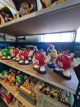 M & M's, a shelf of large figure dispensers and similar