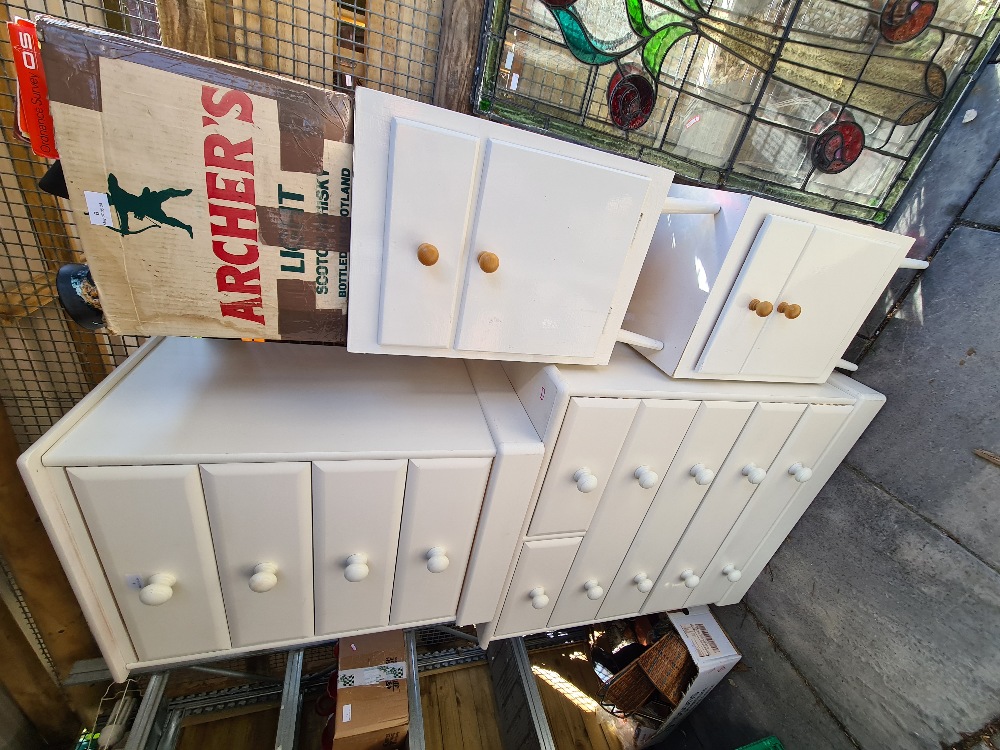 Two white painted pine chest of drawers and a pair of white painted bedside cupboards