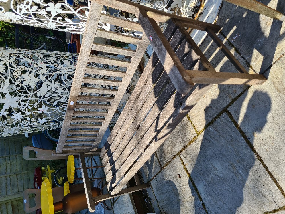 A slatted garden bench - possibly Teak, not sure