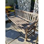 A slatted garden bench - possibly Teak, not sure