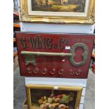 An antique style shop sign for key manufacturer G. Wing & Co