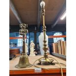 A brass adjustable table lamp and a brass doorstop decorated with a figure of a Pixie