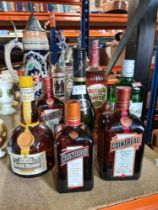 A selection of various bottles including Napoleon Brandy, Cointreau, Grand Marnier, etc