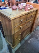 A modern oak chest having two short and 3 long drawers