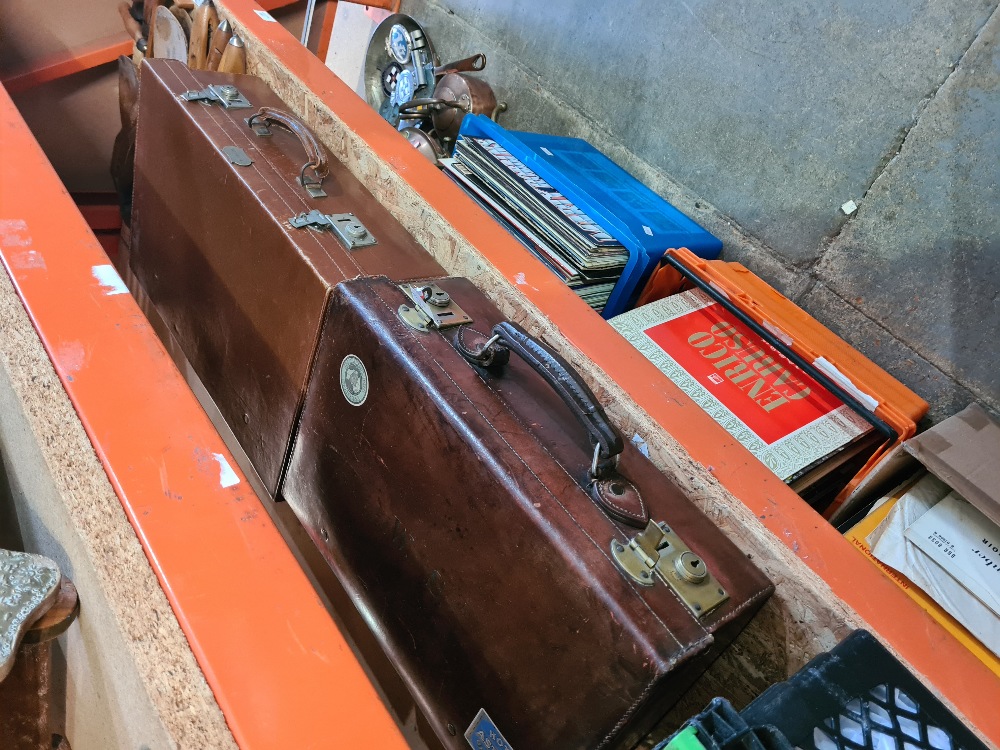 Two old leather suitcases one having fitted interior with bottles and brushes
