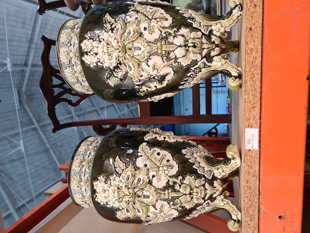 A pair of early 20th Century vases having raised floral decoration on three feet, 37.5cms - Image 3 of 4