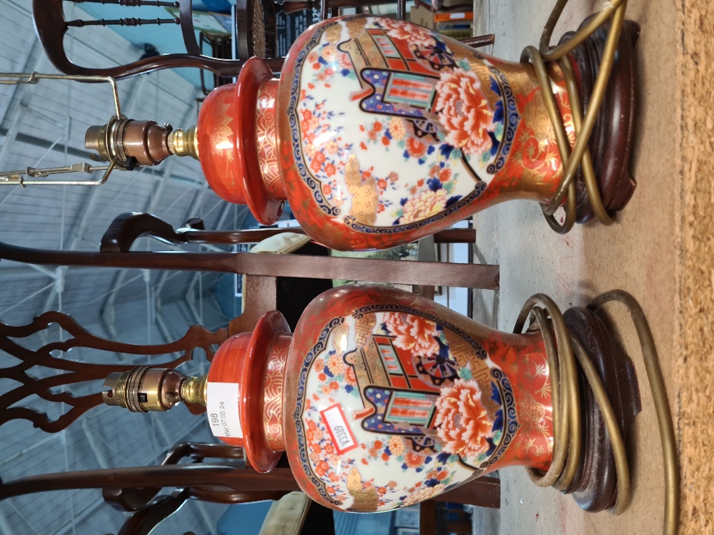 A pair of smaller oriental style table lamps the panels decorated cart and flowers