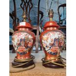 A pair of smaller oriental style table lamps the panels decorated cart and flowers