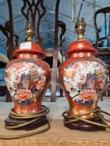 A pair of smaller oriental style table lamps the panels decorated cart and flowers
