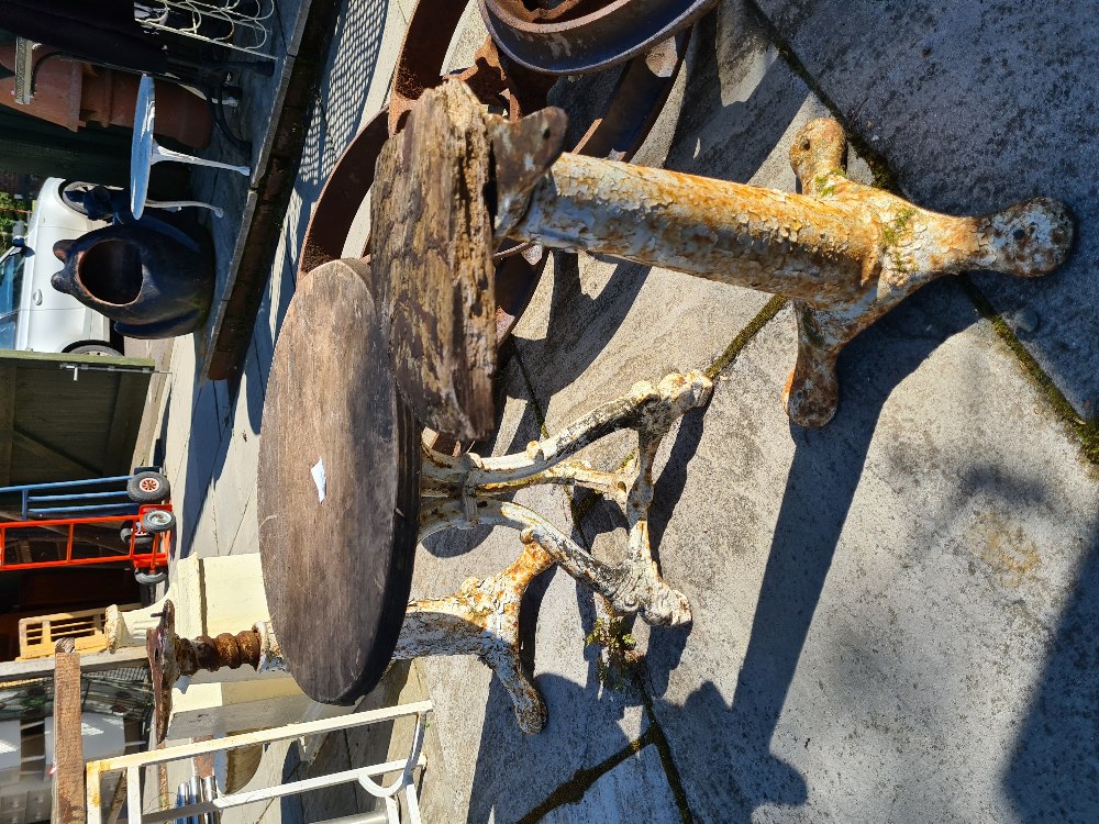 A pair of cast iron revolving bases probably industrial and one other item