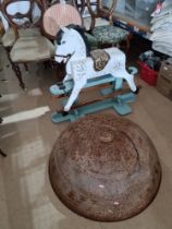 A small children's rocking horse and a large Industrial rusted ceiling shade
