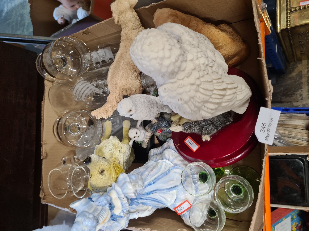 A box of mixed glassware and resin animal figures