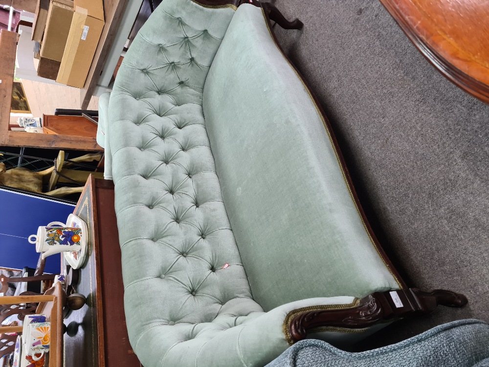 An early 20th Century button back settee, on cabriole legs