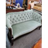 An early 20th Century button back settee, on cabriole legs