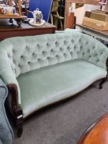 An early 20th Century button back settee, on cabriole legs