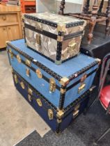 Three modern travelling trunks with metal and studded decoration