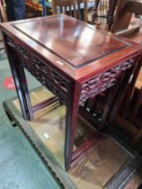 A nest of two modern oriental coffee tables having pierced frieze