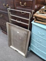 A large metal tray of folding stand and a pair of bamboo style luggage racks