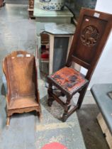 A 20th Century, oak correction chair post 1950, having carved Griffin and one other antique oak chil