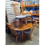 A set of 6 Ercol stickback chairs and an Elm topped 2 flap kitchen table