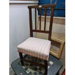 An antique oak nursing chair with stick back