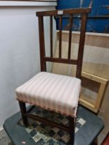 An antique oak nursing chair with stick back