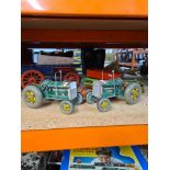 Two vintage tinplate clockwork tractors and other farm accessories (possibly Tri-ang) and a non rela