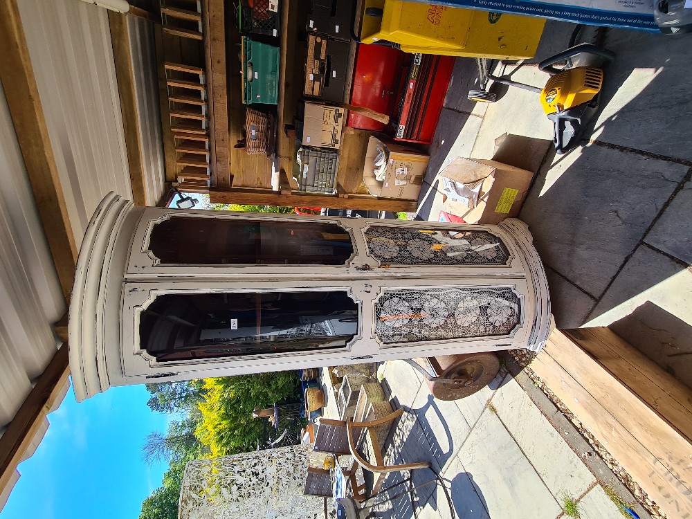 A reproduction painted standing corner display cabinet