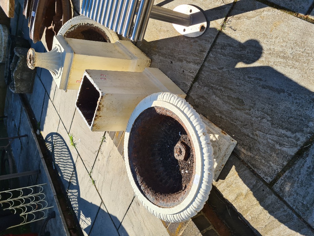 A pair of Victorian style cast iron garden urns on square plinth bases