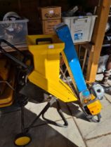 An Alko garden shredder, a McCulloch Gladiator 550 Petrol Lawn Mower and pruner attachment