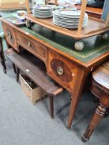 An Edwardian mahogany writing table having three drawers on square tapered legs