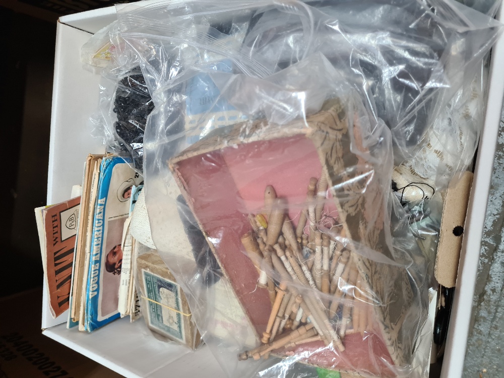 A box of needlework and sewing related items including patterns